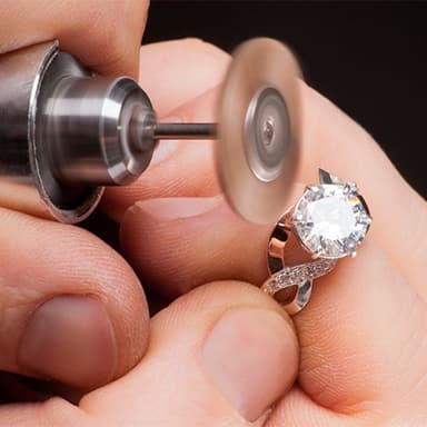 A master jeweler polishing a diamond ring